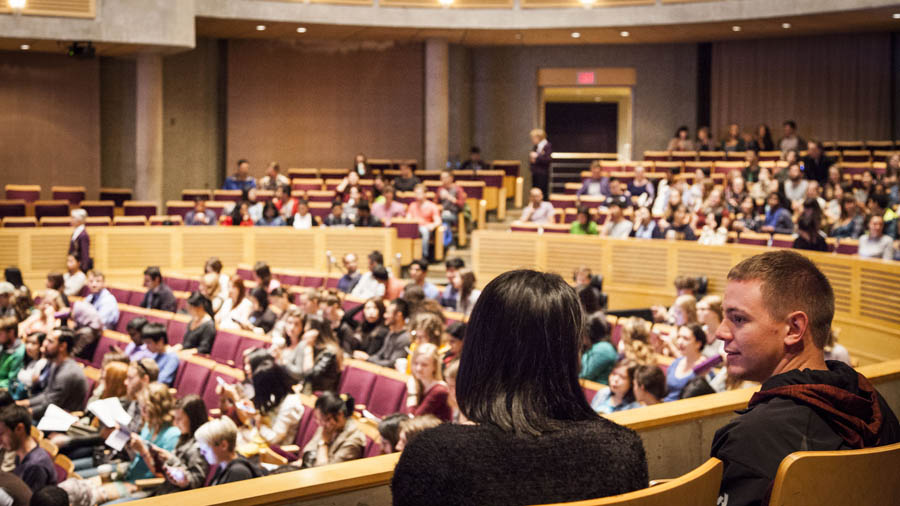Students network in the seats at the Chan Centre.