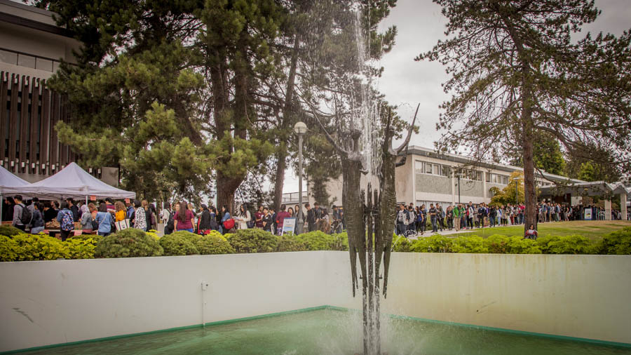 Students mingle behind the Trancendence fountain in front of the Graduate Student Centre.